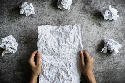 High angle view of human hand on paper