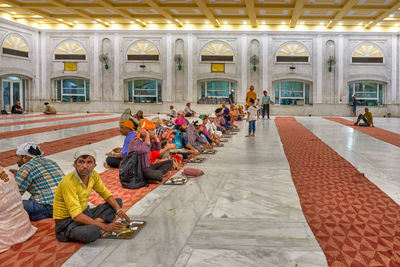 Group of people sitting outside building