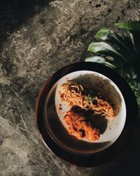 High angle view of noodles and chicken fillet in bowl