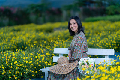 Portrait of a smiling young woman on field