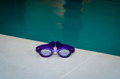 Close-up of sunglasses on swimming pool