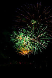 Low angle view of firework display at night
