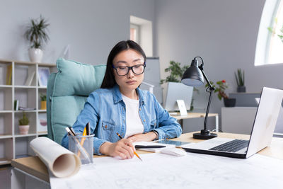 Portrait of young businesswoman working at office