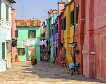 Alley amidst houses in city