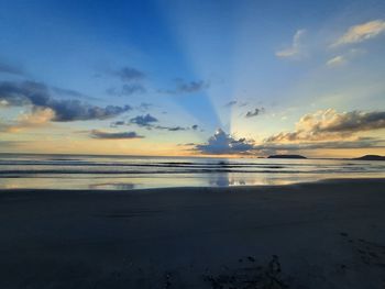 Scenic view of beach against sky during sunset