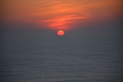 Scenic view of sea against orange sky