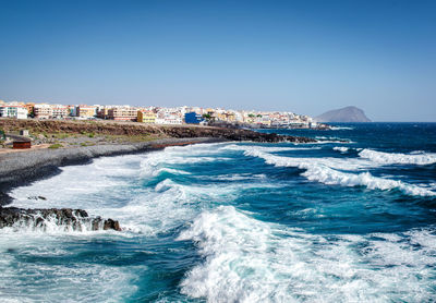 Scenic view of sea against clear blue sky