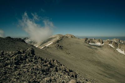 Panoramic view of arid landscape against sky