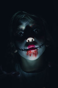 Close-up portrait of girl with spooky face paint