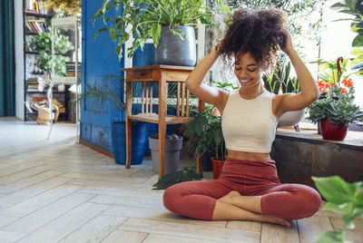 Portrait of young woman sitting on floor