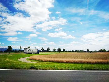 Rural landscape against cloudy sky