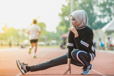 Female athlete exercising on track