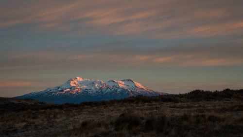 Scenic view of snowcapped mountains against sky during sunset