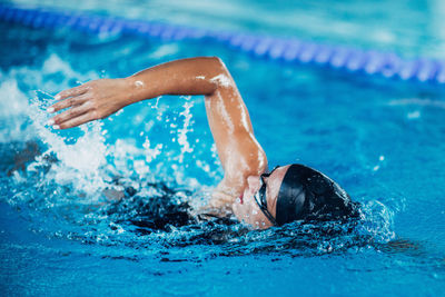 Woman swimming in pool during competition