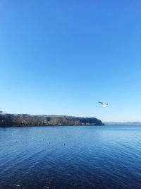 Scenic view of sea against clear blue sky