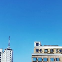 Low angle view of building against clear blue sky