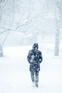 Person standing on snow covered land