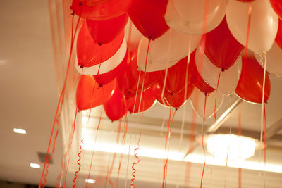 Low angle view of balloons hanging against ceiling