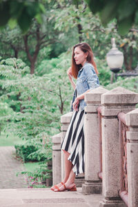 Woman looking away while sitting outdoors