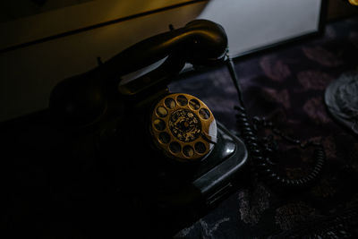 Close-up of rotary phone on table