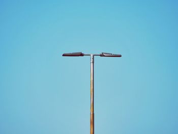 Low angle view of street light against clear blue sky