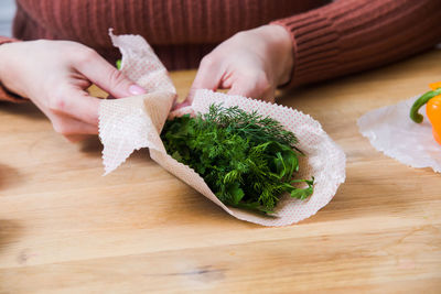 Midsection of person preparing food on table
