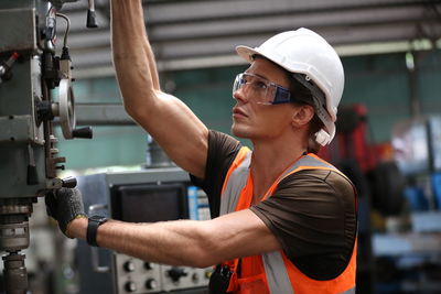 Side view of man working at construction site