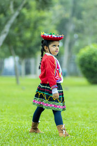 Full length of cute girl standing on grass