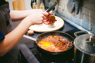 Midsection of woman preparing food in kitchen