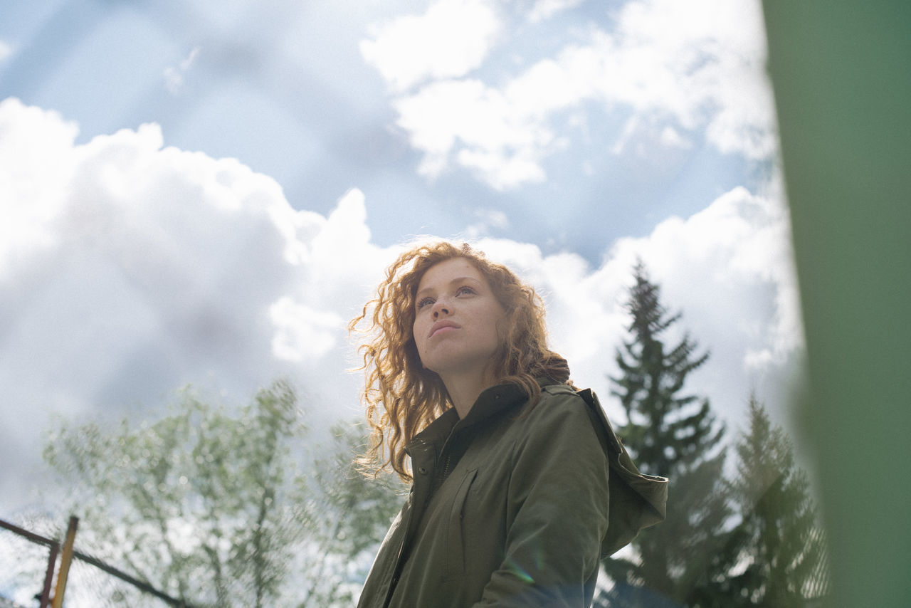 one person, cloud - sky, sky, young adult, leisure activity, real people, portrait, lifestyles, day, tree, plant, winter, nature, warm clothing, beauty in nature, low angle view, clothing, young women, hair, outdoors, contemplation, hairstyle, beautiful woman