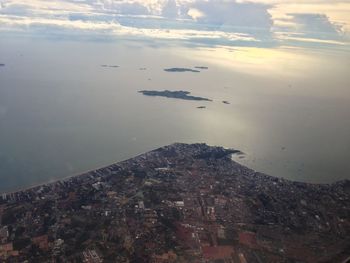 High angle view of cityscape by sea against sky