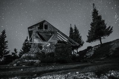 Low angle view of built structure against clear sky at night