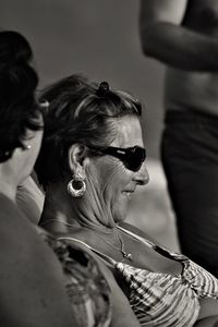 Portrait of woman holding sunglasses