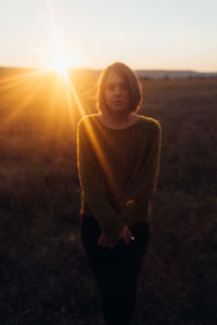 Portrait of smiling girl on landscape at sunset