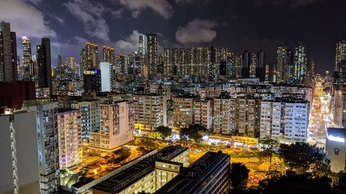 Illuminated cityscape against sky at night