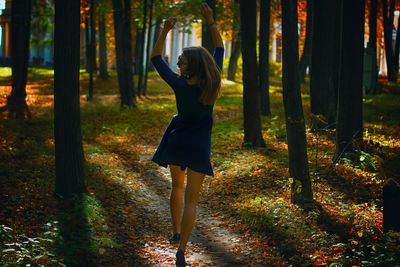 Rear view of happy woman in park