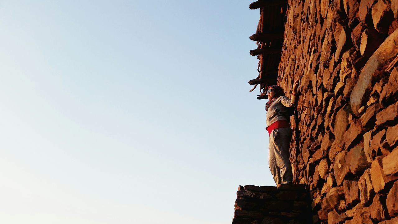 LOW ANGLE VIEW OF BUILT STRUCTURES AGAINST CLEAR SKY