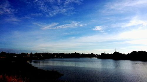 Scenic view of river against cloudy sky