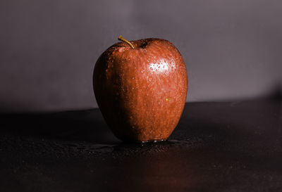 Close-up of wet apple on table