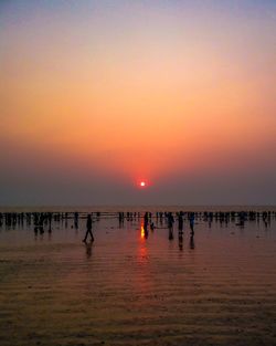 Scenic view of sea against sky at sunset