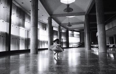 Little girl in empty hallway