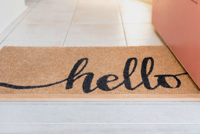 High angle view of hello text on doormat