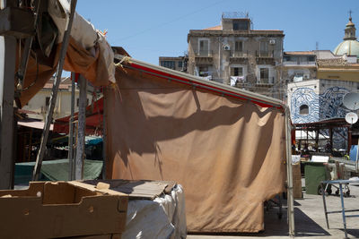 Clothes drying against buildings in city