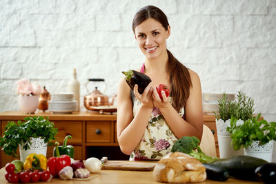 Portrait of woman preparing food on kitchen island at home