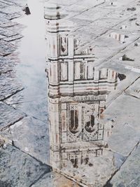 Reflection of building in puddle