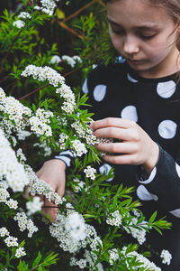 Cute girl touching flowering plants