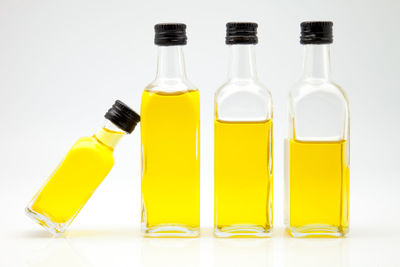 Close-up of yellow bottles against white background