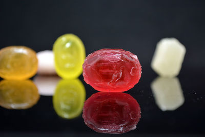 Close-up of multi colored candies against black background