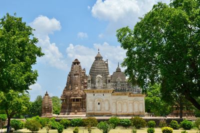 View of temple at khajuraho against cloudy sky