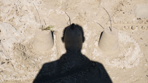 Shadow of man and woman on sand